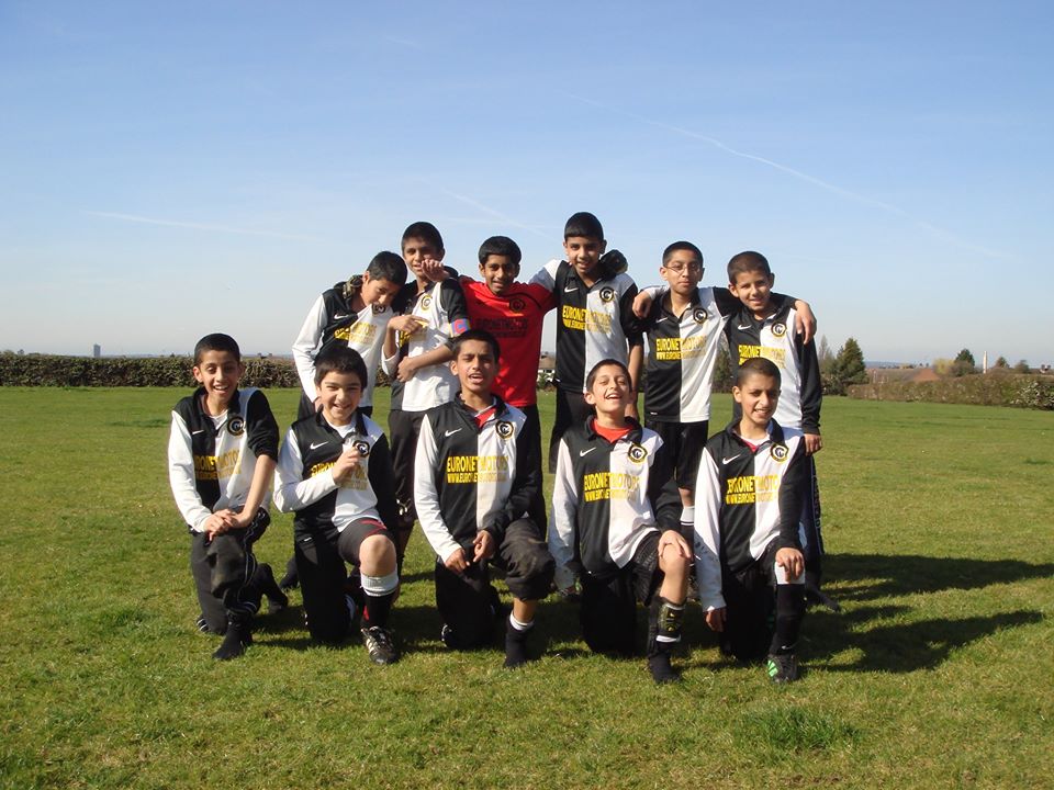 ICCF players and coaches posing together as a team